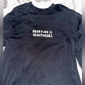 ¢hange Long-Sleeved Black shirt with design on front and back